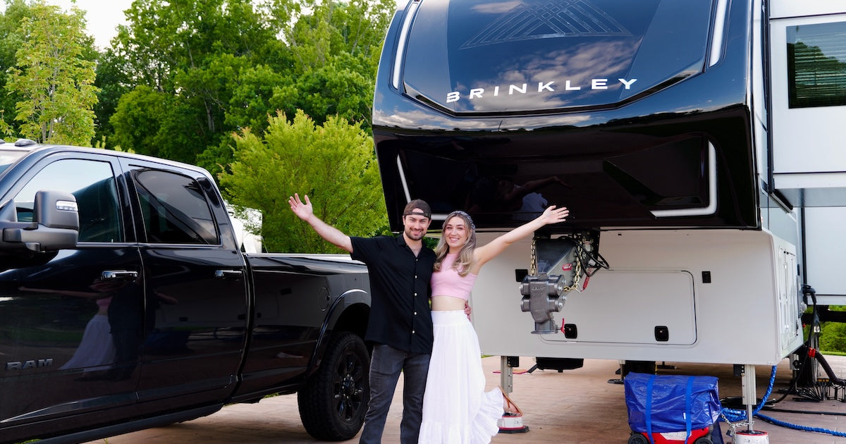 Zach and Ryan welcoming the audience in front of their RV and truck.